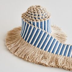 a blue and white hat with fringes on it