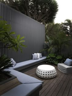 an image of a patio with furniture and plants on the deck area, which is also used for seating