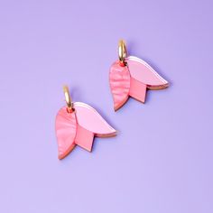 These Tulip charms add a lovely monochrome pop of color and are small and cute enough for when you want to be a little subtle. Hand-crafted from a combo of marbled, mirrored and frosted acrylic, paired with hand-stained wood. They hang from elegant 15mm gold-filled hoops and are removable so you can wear the hoops on their own—two earrings in one, perfect for travel! Hand-crafted in New York City. Gold-filled hoops are perfect for sensitive ears! Due to the hand-made nature of these pieces, your Diy Resin Earrings, Tulip Earrings, Two Earrings, Blue Charm, Hoop Charms, Frosted Acrylic, Purple Tulips, Gold Filled Hoops, Pearl Collection