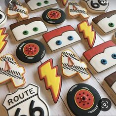 decorated cookies are arranged in the shape of cars and road signs, along with numbers