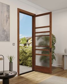 an open door leading to a living room with a view of the outside and inside