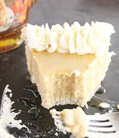 a piece of cake with white frosting on top and a fork next to it