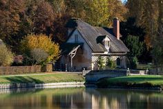 an old house with a bridge over the water