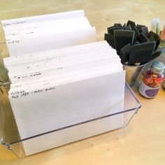 a stack of papers sitting on top of a table next to some bottles and containers