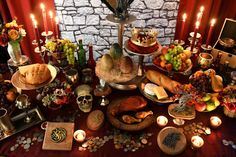 a table topped with lots of food and candles