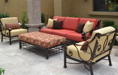 a red and beige couch sitting on top of a patio