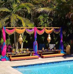 an outdoor wedding setup next to a swimming pool