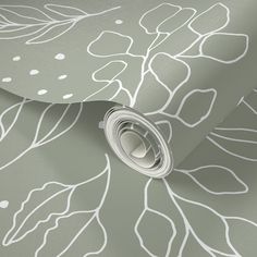 a close up view of a wallpaper with leaves and dots on the paper,