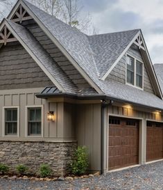 a large house with two garages in the front and one on the other side