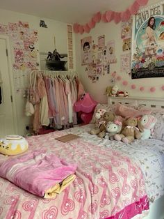 a bedroom decorated in pink and white with lots of stuffed animals on the bedspread