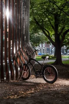 a bike parked next to a metal structure