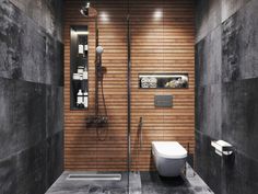 a modern bathroom with wood paneled walls and flooring, including a walk in shower