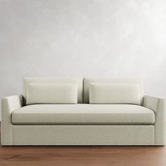 a white couch sitting on top of a wooden floor