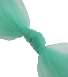 a green tulle tied to the side of a headband on a white background