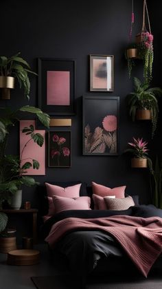 a bedroom with black walls, pink and black bedding, potted plants and pictures on the wall