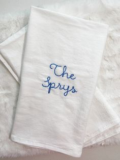 two white towels with the words the sprays embroidered on them sitting next to each other