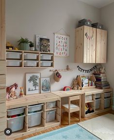 a child's playroom with wooden shelves, toys and storage bins on the wall