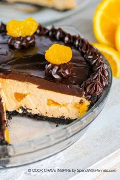 a chocolate and orange cheesecake on a glass plate