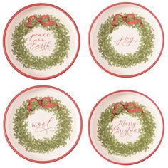 four plates with christmas wreath designs on them