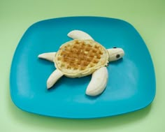 a waffle shaped like a turtle on a blue plate