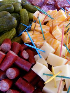 assorted meats and vegetables on sticks with toothpicks stuck in them to look like they are eating something