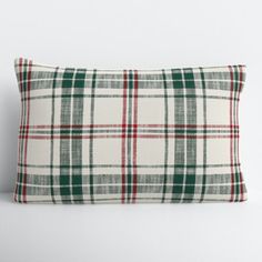 a white and green plaid pillow sitting on top of a table