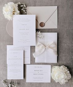 the wedding stationery is laid out and ready for guests to arrive