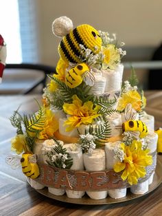 a diaper cake decorated with bees and flowers