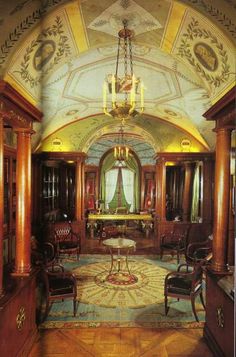 an ornately decorated hallway with wooden furniture and chandelier