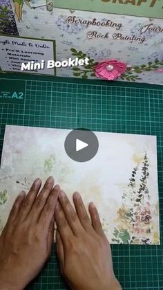 someone is making a mini booklet with their hands