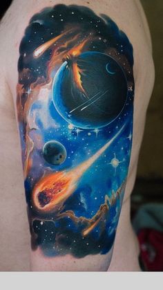 a man's arm with an image of planets and stars on it