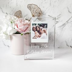 a vase with flowers in it and a happy 25th birthday photo on the front side