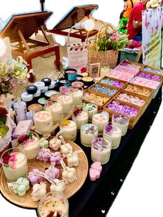 a table filled with lots of desserts and candles on it's display stand