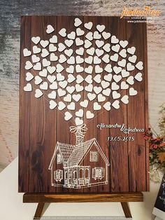 a family tree with hearts attached to it on top of a wooden easel in front of a wall