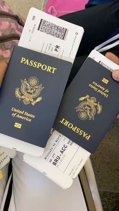 two people holding up their passport cards