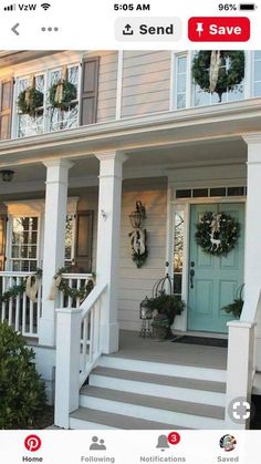 front porch decorated for christmas with wreaths and decorations