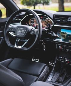 the interior of an audi car with dashboard and steering wheel, including touchscreens