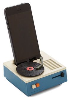 an old - fashioned record player with a phone on it's stand, sitting in front of a white background