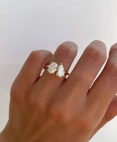 14k Gold Engagement Ring, Pear Cut Toi Et Moi Ring, Oval Cut Ring, Pear Ring, Moissanite Ring, 14K Yellow Gold Ring Anniversary Ring, Two Stone Ring, Wedding Ring, Ring For Women, Promise Ring  💍 RING DESCRIPTION💍 - Metal: 925 Sterling Silver/14K White/Rose/Yellow Gold - Stone: Lab Diamond/Moissanite - Main Stone Weight: 2.5 Carat Approx. (1.25 Carat each) - Stone Color: Colorless - Stone Shape: Pear and Oval Cut - Clarity: VS/VVS - Cut Grade: Excellent - Polish: Excellent - Eco-friendly - Nic Oval Cut Gold Engagement Ring 2 Stones, 2 Stone Wedding Ring Gold Band, Yellow Gold Anniversary Rings, White Topaz Engagement Ring, Stone Wedding Ring, Engagement Ring Pear, Gold Anniversary Rings, Pear Cut Engagement Rings, Ring Rosegold