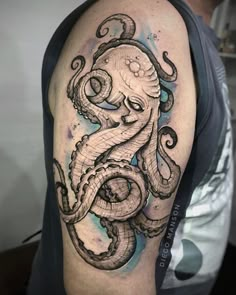 an octopus tattoo on the arm with watercolors and ink in black and white