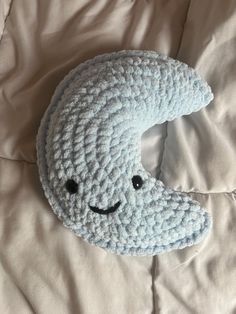 a crocheted pillow with a smiling face