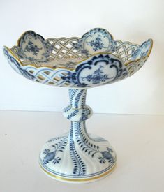 a blue and white bowl sitting on top of a table