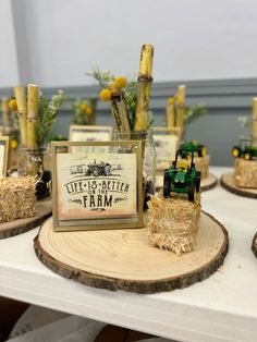 a table topped with wooden slices and small vases filled with flowers on top of each other