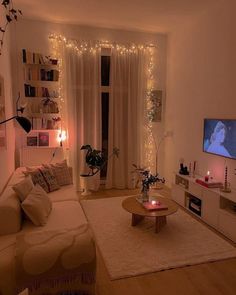 a living room filled with furniture and a flat screen tv on top of a wooden table