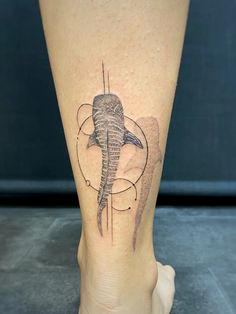 an elephant tattoo on the leg of a woman