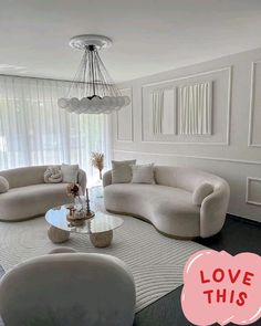 a living room filled with furniture and a chandelier