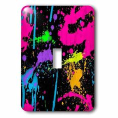 a light switch cover with colorful paint splatters on black and neon pink background