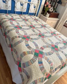 a bed with a quilt on top of it