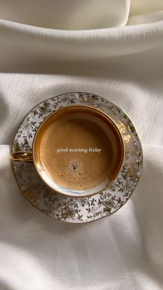 a cup of coffee sitting on top of a saucer with the words good morning friday written in it