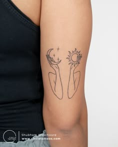 a woman's arm with a sun and moon tattoo on the left side of her body